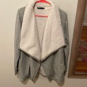 Cardigan w/sweatshirt material outside and Sherpa in vest shape on the inside